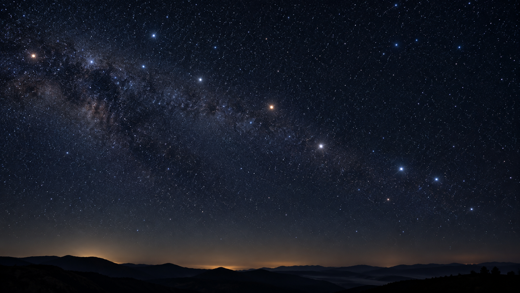 夜空に黄道が弧を描く星空